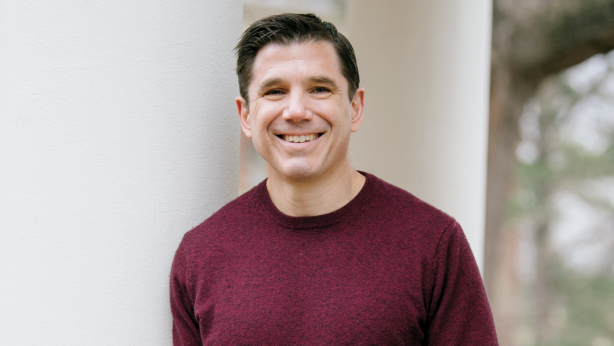Man in red shirt smiling